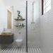 small apartment bathroom under $100 makeover with subway tile floating shelves and plants