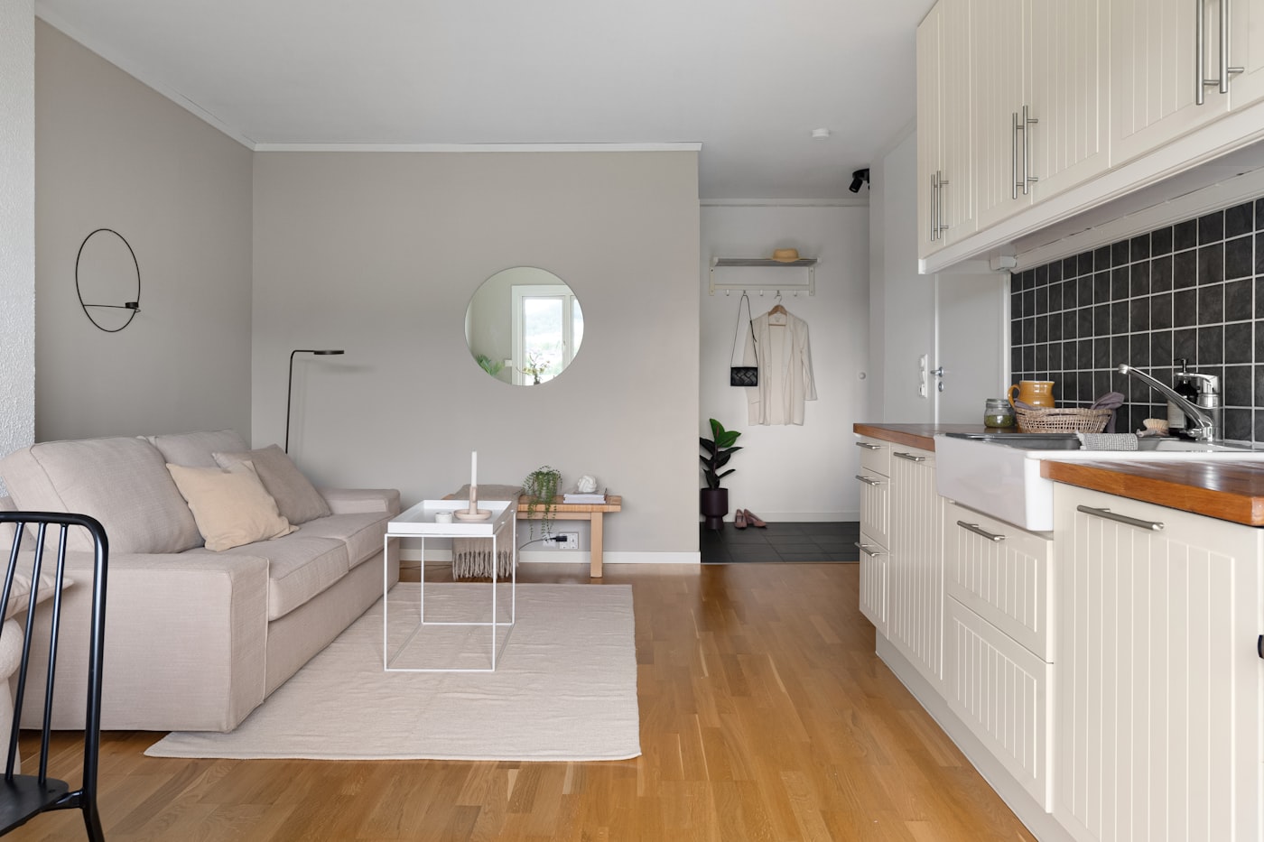 Affordable first apartment living room with simple sofa side table and minimal furniture for a college graduate