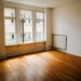 Empty first apartment with hardwood floors waiting to be furnished by a college graduate
