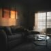 Cozy apartment living room with warm golden light glowing through large window and sectional sofa