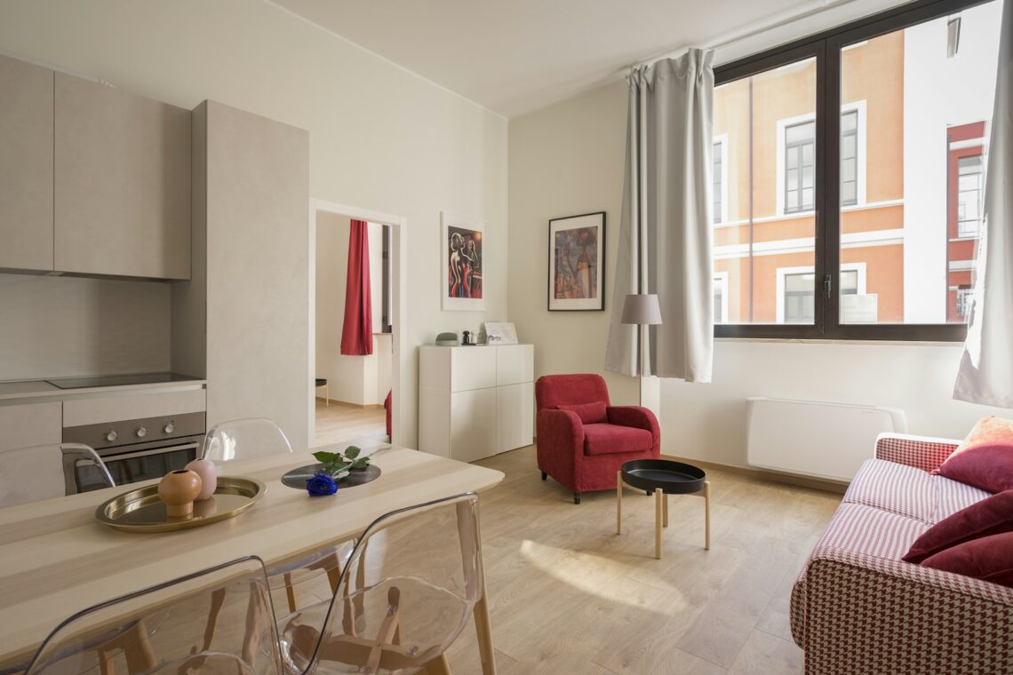 small apartment decor for young professionals with red chair sofa and modern kitchen