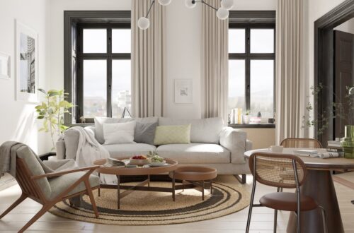 500 sq ft studio apartment with light sofa accent chair dining table and large windows