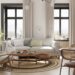 500 sq ft studio apartment with light sofa accent chair dining table and large windows