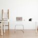clean white compact desk with laptop in a small studio apartment