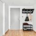 Scandinavian small apartment entryway with wall-mounted shelf and hooks above door height