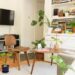 cozy apartment living room with monstera plants bookshelves and mid-century chair