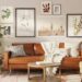 Boho small apartment living room with tan leather sofa, layered gallery wall art, fiddle leaf fig, and woven plant baskets on a vintage rug