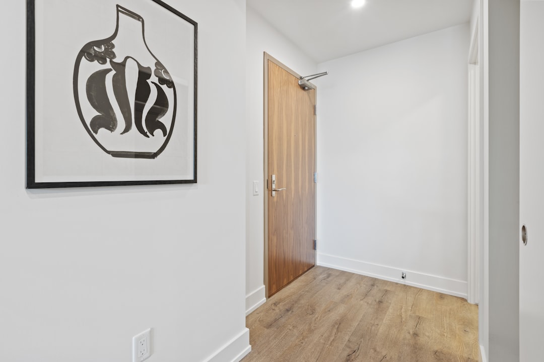 Modern apartment corridor with bold black and white framed art print near front door