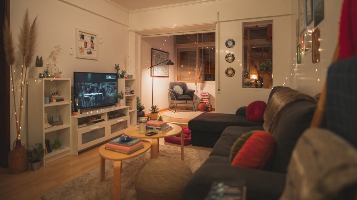 cozy small apartment living room with fairy lights and warm amber glow