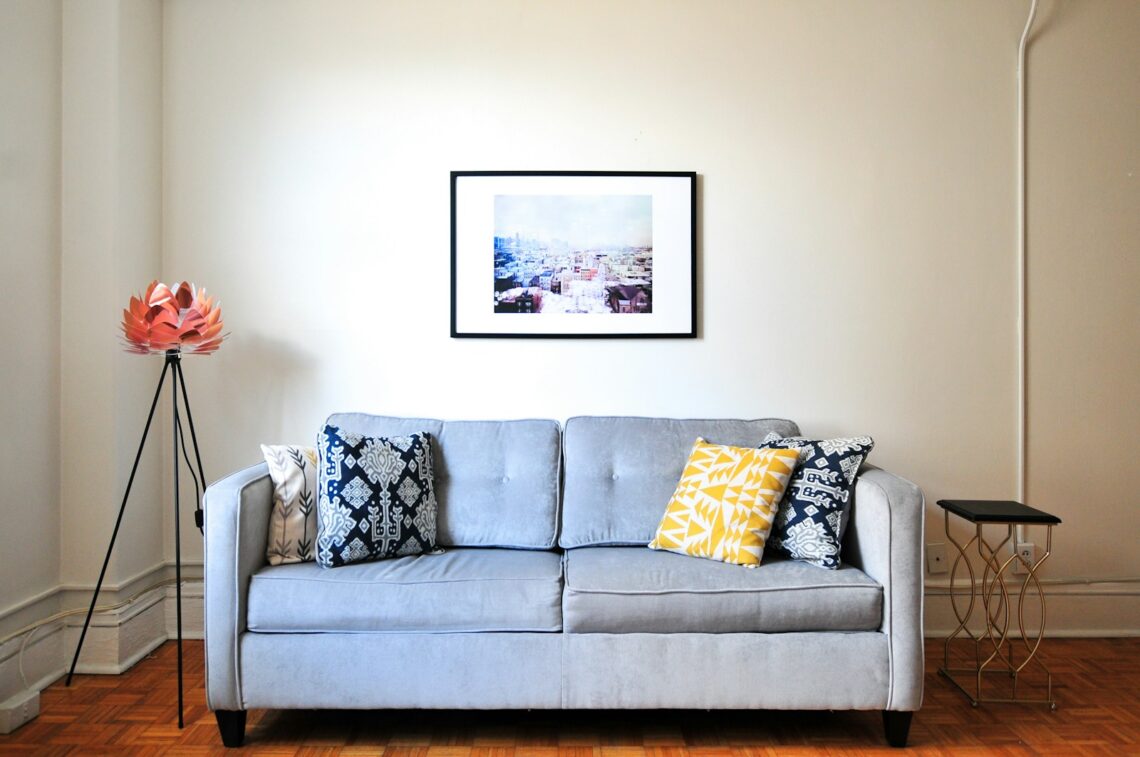 gray sofa with colorful throw pillows in a small apartment living room