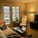 Cozy small apartment living room furnished with IKEA sofa, armchair, coffee table and floor lamp