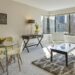 bright small apartment living room with dining area and city views through large windows