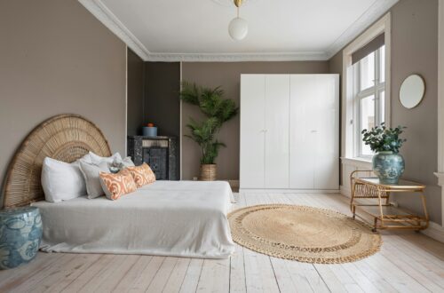 Scandinavian cozy bedroom with rattan headboard and plant